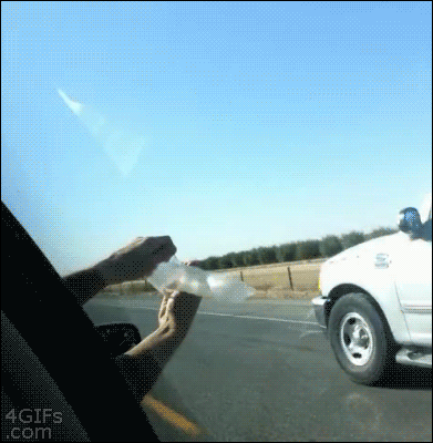 Holding a condom out a car window